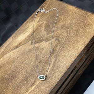 Silver tone necklace with green stone